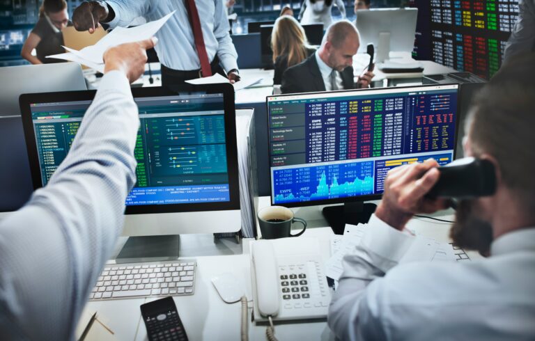 Financial market data displayed across multiple digital screens showing investment portfolios, asset performance, charts, analytics and market information as public and private market infrastructure converges.